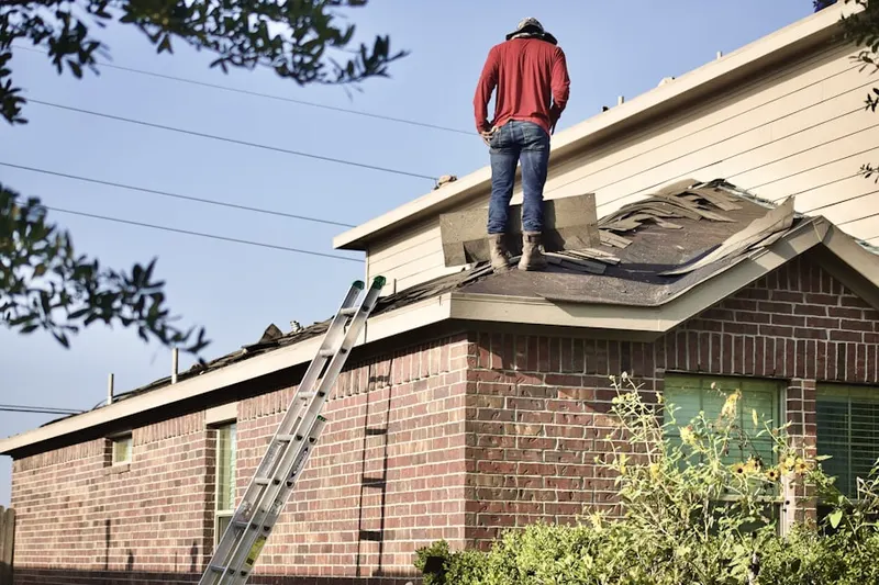 Professional roofer working on a residential roof in North Caldwell